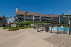 a apartment complex with a swimming pool and a building at Harbours 10- Condo with community pool in South Haven