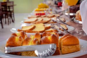 a plate of bread with a knife and fork on it at Hotel Geneve - 2km do Capivari in Campos do Jordão