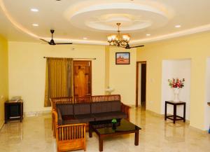 a living room with a couch and a table at Janz Marina Bay in Puducherry