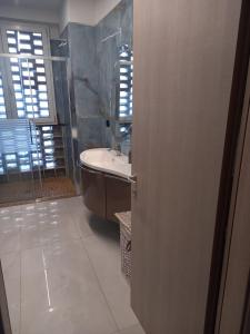 a bathroom with a bath tub and a sink at Casa Aurelia in Imola