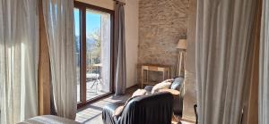 a living room with two chairs and a fireplace at Agriturismo La Pina in Tarzo