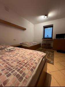 a bedroom with two beds and a television in it at Star in Poprad +17 photos
