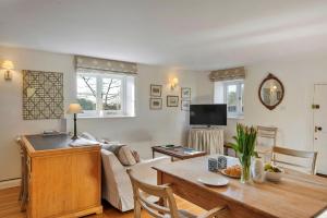 a living room with a couch and a table at Finest Retreats - Stable Cottage at Yealmpton in Yealmpton