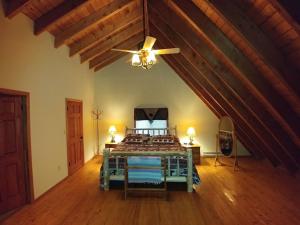 a bedroom with a bed with a ceiling fan at Pocono Mountain Retreat in Cresco