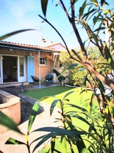 a house with a yard with green grass at Studio jardin privatif 300m de la plage in Sainte-Maxime