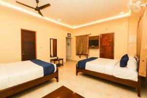 a bedroom with two beds in a room at Janz Marina Bay in Puducherry +54 photos