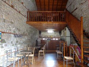 une salle à manger avec des tables et des chaises et un escalier dans l'établissement Alonaki Guesthouse, à Plátanos