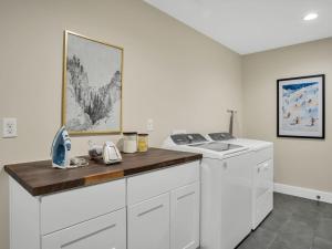a white laundry room with a washer and dryer at 4BD Home - Games - Close to Downtown & Snowbowl in Flagstaff +43 photos