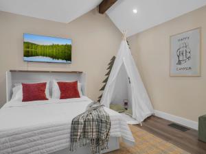 a bedroom with a white bed and a tent at 4BD Home - Games - Close to Downtown & Snowbowl in Flagstaff