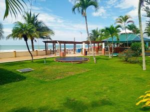 a park next to the beach with palm trees at Playa Almendro Resort - Tonsupa in Tonsupa