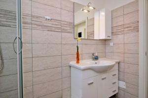 a bathroom with a sink and a mirror at Apartment Ivo P. in Šilo +54 photos