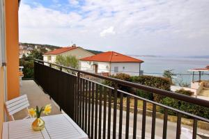 a balcony with a table and a view of the ocean at Apartment Ivo P. in Šilo