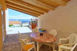 a table and chairs on a patio with a view at Apartment Ivo P. in Šilo