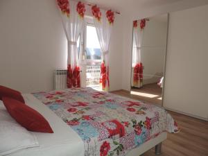 a bedroom with a bed with a quilt on it at Holiday Home Voloder in Tarabnik +29 photos