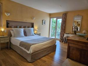 a bedroom with a large bed and a mirror at La Terre d'Or in Beaune +93 photos