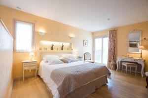 a bedroom with a large bed and a mirror at La Terre d'Or in Beaune