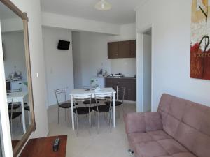 a living room with a couch and a table at Fantasia Hotel Apartments in Kos