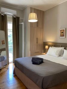 a bedroom with a large bed and a pendant light at Yia Sou Corfu! "Kolibri" in Sinarádes