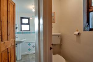 a bathroom with a toilet and a sink at Finest Retreats - Wolf Rock in Sennen +17 photos