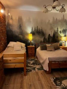 a bedroom with two beds and a painting on the wall at Dom z Charyzmą na Mazurach in Miłki