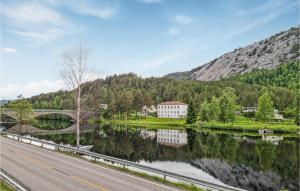 a road next to a river with a bridge at Stunning Apartment In Åmli With Wifi in Åmli