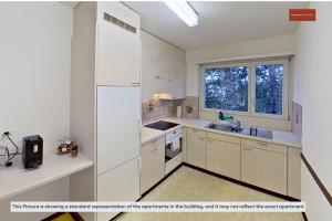 a kitchen with white cabinets and a sink and a window at Charming Apartment 15 Mins from City Life in Zürich +17 photos