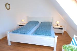 a bedroom with two beds and two night stands at Ferienhaus Veldhoen in Norddeich