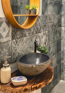 a bathroom with a stone sink and a mirror at Jedinečné bývanie v blízkosti Banskej Štiavnice in Banský Studenec