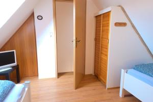 a room with a staircase and a room with a door at Ferienhaus Veldhoen in Norddeich
