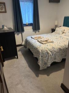 a bedroom with a bed with towels on it at Black Bull Barn in Kirkby Stephen