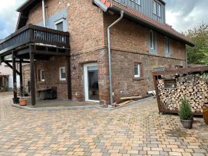 a brick building with a balcony and a brick patio at Apartment Katz in Berghausen