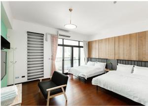 Rúm í herbergi á Chenting Yiyu B&B