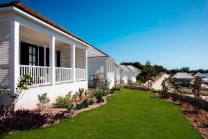 a row of houses with a lawn in front at French Leave Resort, Autograph Collection in Governorʼs Harbour