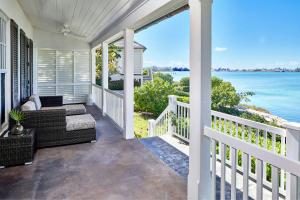 a porch with a view of the water at French Leave Resort, Autograph Collection in Governorʼs Harbour