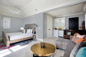a large living room with a bed and a couch at French Leave Resort, Autograph Collection in Governorʼs Harbour