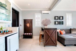 a living room with a couch and a table at French Leave Resort, Autograph Collection in Governorʼs Harbour