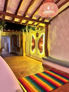 a room with a colorful rug on the floor at Habitación doble Monarca 2 ó 3 camas in Barichara