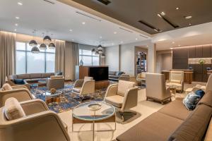 a waiting room with couches and a tv at Courtyard by Marriott Fort Lauderdale Downtown in Fort Lauderdale