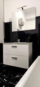 a white dresser with a sink and a mirror at Vittoria's rooms in Rome +37 photos