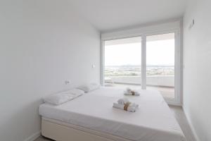 Voodi või voodid majutusasutuse Global Properties, Apartamento con vistas al mar, 2 terrazas y piscina en Canet d'en Berenguer toas +39 fotot