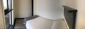 a white chair in a room with a window at Olas de Pichicuy in Guaquen