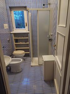 a bathroom with a toilet and a sink at On Lake Villa Cicci e Sandro in Bellano