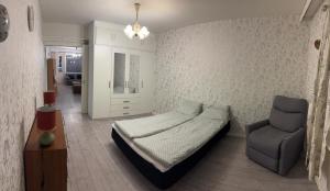 a bedroom with a bed and a chair in it at Northern apartments in Kemi