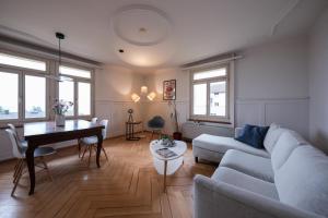 a living room with a couch and a table at Boutique Apartment Lakeview Luzern 2 in Luzern