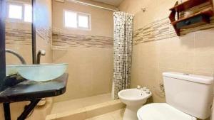 a bathroom with a sink and a toilet at Hermoso depto con pileta en Santa Elena in Santa Clara del Mar
