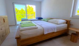 a bedroom with a large bed with two windows at Villa Anto in Pridraga +37 photos