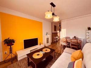 a living room with a couch and a table at Apartament Sofia in Sibiu