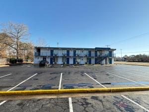 a parking lot in front of a building at Relax Inn in Hampton