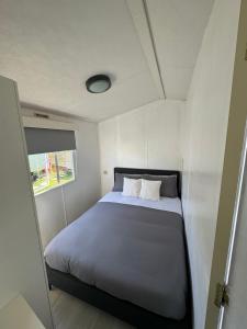 ein Schlafzimmer mit einem Bett in einem kleinen Zimmer in der Unterkunft Hosting4U in Felpham