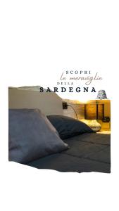 a bedroom with two beds and a sign that reads scots university of barcelona at "La casa di Ryan" - Camere -Tra Cagliari e il Mare in Monserrato +28 photos